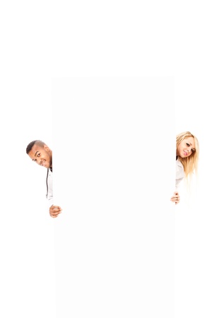 photo of smiling young doctors in front of a white message board, stockphotoの写真素材