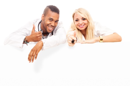 photo of smiling young doctors in front of a white message board, stockphotoの写真素材