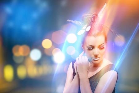 photo of beautiful woman standing in a colorful cityの写真素材