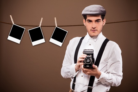 Photo of ancient photographer from the 30s in front of a polaroid backgroundの写真素材