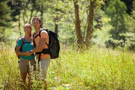 Young couple is doing tracking in the woodsの写真素材