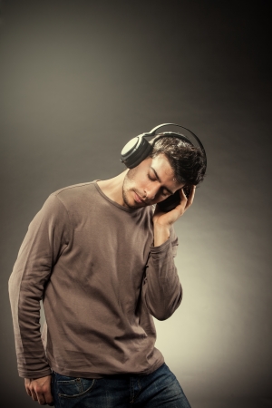 Photo of man who is listening to music while wearing headphonesの写真素材