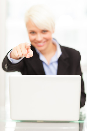 Image of young female manager with notebook in her officeの写真素材