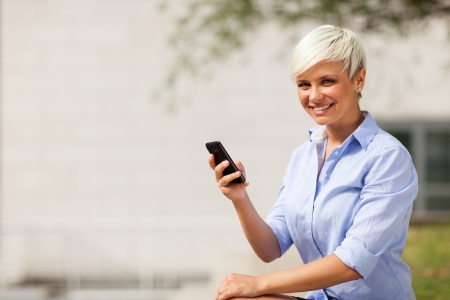 Photo of blonde businesswoman with mobilephoneの写真素材