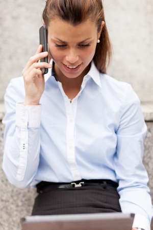 Photo of brunette businesswoman who is phoningの写真素材