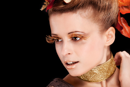 Beauty photo of woman with autumn makeup over black backgroundの写真素材