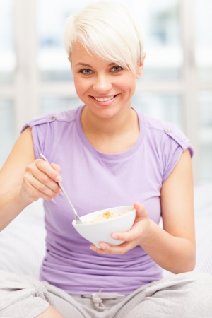Conceptual breakfast photo of woman eating flakesの写真素材