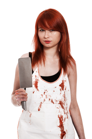 Red hair female buttcher with knife and blood on apronの写真素材