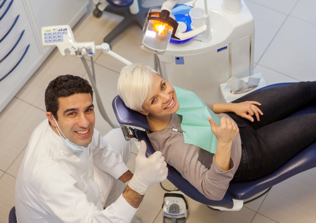 photo of male dentist and his patient in a dentist officeの写真素材