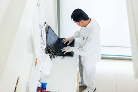photo of asian dentist working on a computer in his officeの写真素材