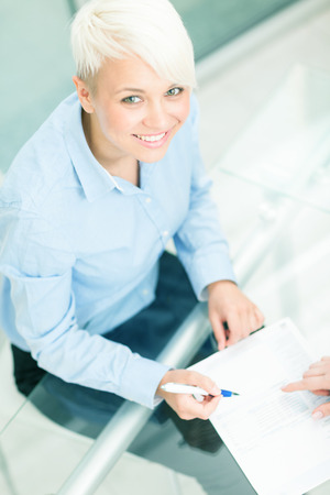 Top shot of caucasian female manager with contract on the tableの写真素材