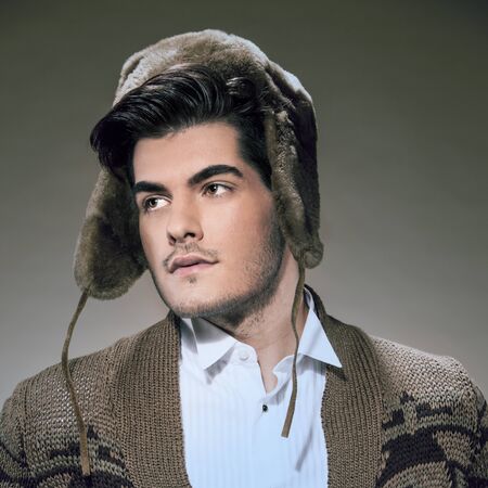 Winter fashion photo of caucasian guy with warm hatの写真素材