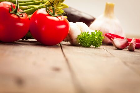 Photo of colorful vegetables over old wooden tableの写真素材