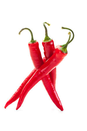 Spicy red peppers over white isolated backgroundの写真素材