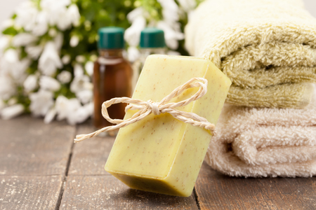 Photo of olive soap over wooden tableの写真素材