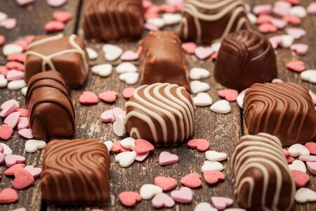 Photo of chocolate pralines over wooden tableの写真素材