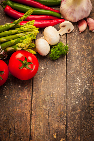 Photo of colorful vegetables over old wooden tableの写真素材