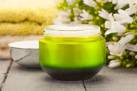 Photo of face cream over wooden tableの写真素材