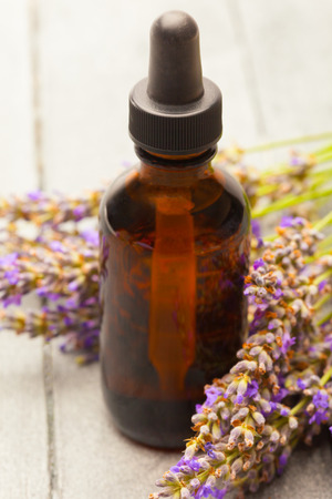 photo of lavender essential oil over wooden tableの写真素材