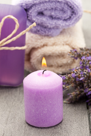 Photo of candle and lavender soap over wooden tableの写真素材