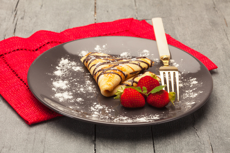 Pancake with strawberry over wooden tableの写真素材