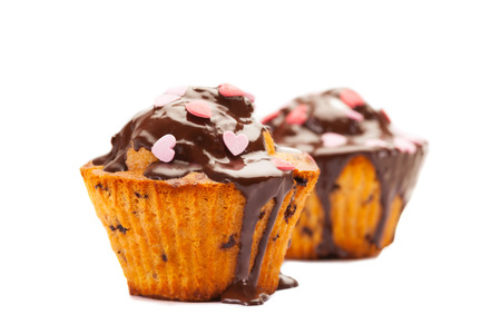 Photo of tasty cupcakes with chocolate over white isolated backgroundの写真素材