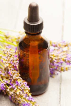 photo of lavender essential oil over wooden tableの写真素材