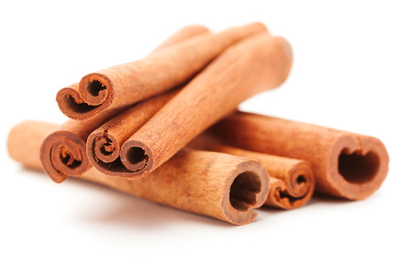 Photo of cinnamon sticks over white isolated backgroundの写真素材