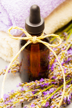 photo of lavender essential oil over wooden tableの写真素材