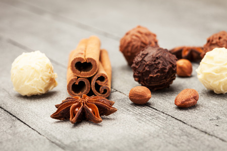 Chocolate truffles and spices over wooden tableの写真素材