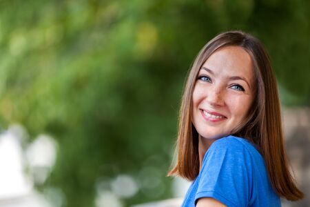 Portrait of smiling brunette woman outdoorの写真素材