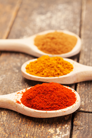 Photo of colorful spices over wooden tableの写真素材
