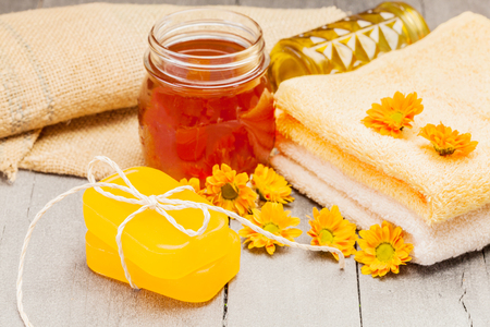 Photo of honey soap over wooden tableの写真素材