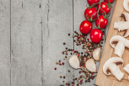 Photo of sliced mushrooms and spices over wooden tableの写真素材