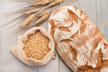 Photo of wheat bread over wooden tableの写真素材