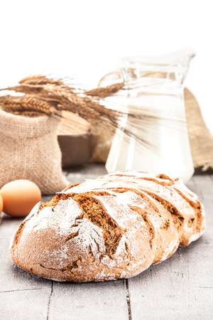 Photo of wheat bread over wooden tableの写真素材