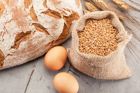 Photo of wheat bread over wooden tableの写真素材