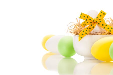 Photo of yellow easter eggs over white isolated backgroundの写真素材