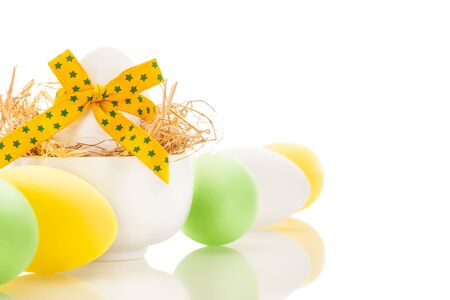 Photo of yellow easter eggs over white isolated backgroundの写真素材