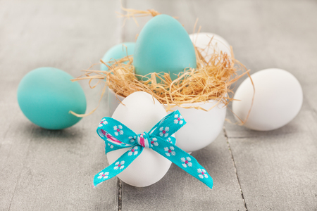 Photo of easter eggs over wooden tableの写真素材