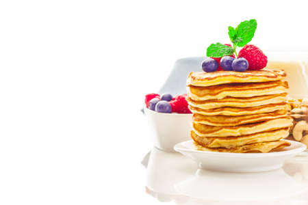 Photo of pancakes with berries over white isolated backgroundの写真素材