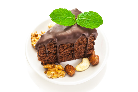 Photo of piece of chocolate cake over white isolated backgroundの写真素材