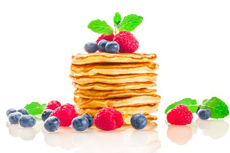Photo of pancakes with berries over white isolated backgroundの写真素材