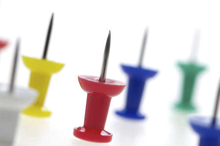 colorful push pins - multicolored pins isolated on white