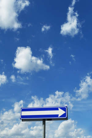 signpost - direction under a blue cloudy skyの写真素材