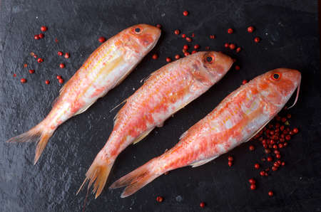 Fresh fish on black backgroundの写真素材