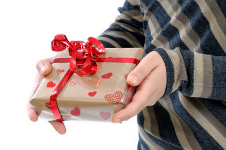 Hands hold out the gift on the occasion of Valentine
