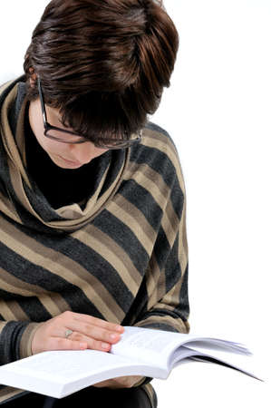 Student reading a book, photographed on white background.の写真素材
