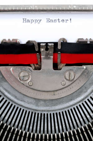Happy Easter text in English written with an old typewriter, vertical photoの写真素材