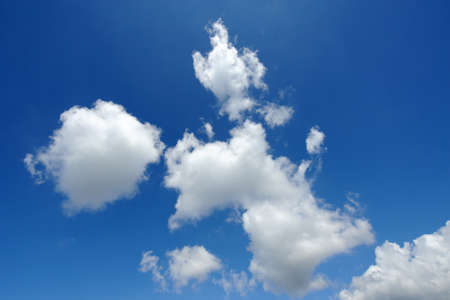 Winter image of a blue sky with white cloudsの写真素材